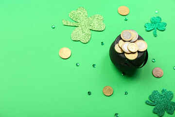 Pot with coins, clovers and sequins on green background, closeup. St. Patrick's Day celebration