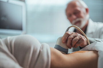 Ultrasound scanner in the hands of a doctor. Diagnostics. Sonography. Gynecologist in sterile...