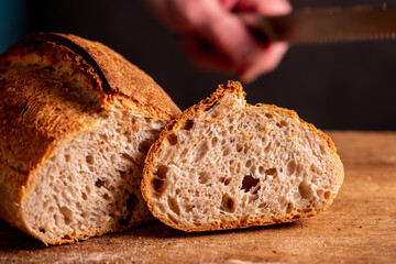 man cutting homemade bread