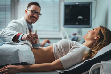 Ultrasound scanner device in hand of professional doctor examining his patient. Expecting...