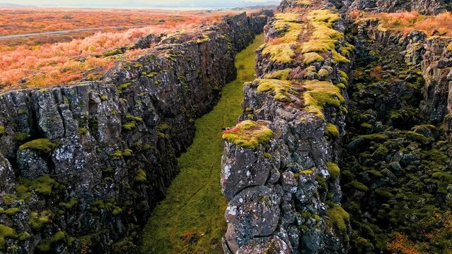 Rise up drone shoot from inside the canyon where two tectonic plates meet in Thingvellir National Park, Iceland