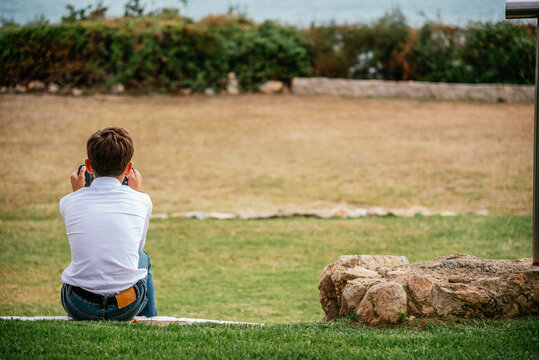 child alone playing video games in a garden