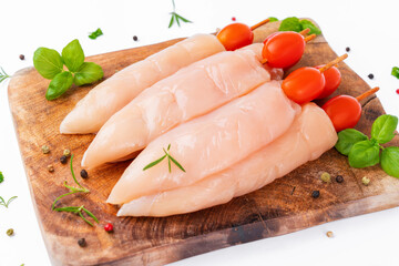 Raw chicken inner on skewers with tomatoes white background with spices, herbs.Raw uncooked Chicken meat,kebab on skewers.skewers raw meat and vegetables.Top view.Chicken Skewers breast fillet meat.