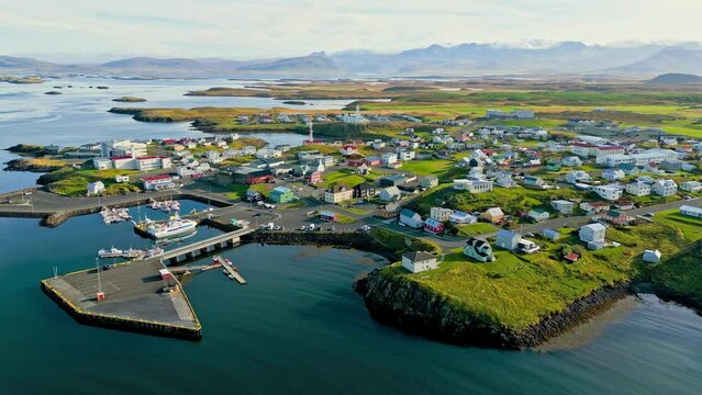 Stykkisholmur town with typical Icelandic fishing harbor - Zoom out drone footage