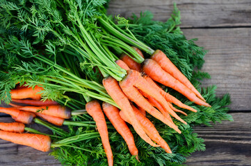 carrot on wooden table background, Fresh and sweet carrots for cooking food fruits and vegetables for health concept, baby carrots bunch and leaf