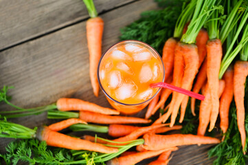 carrot juice on wooden table background, fresh and sweet carrot slices for cooking food fruits and vegetables for health concept, fresh carrots juice on glass with ice on summer