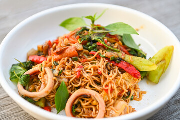 noodles plate with instant noodles stir fried with vegetables herb spicy tasty appetizing asian noodles mix seafood stir fried squid with basil and chilli pepper
