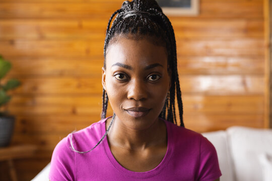Portrait of happy african american woman spending time in log cabin