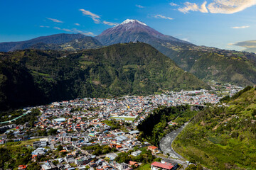 The village Banos de Agua Santa in the Ecuador seen from a distance with the Tungurahua volcano in...