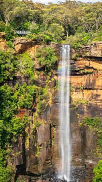Vertical view with a rainbow at Fitzroy Falls in Morton National Park in Kangaroo Valley, Southern Highlands, NSW, Australia.