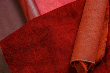 Natural red shades.Texture of red leather.surface of natural pieces of leather in burgundy and red...
