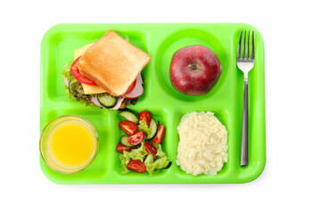 Green tray with tasty food and juice on white background, top view. School lunch