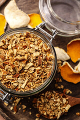 Tray with jar of dried orange zest seasoning on wooden table, flat lay