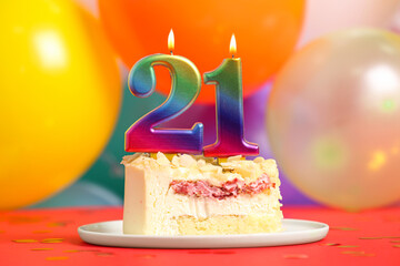 Coming of age party - 21st birthday. Delicious cake with number shaped candles on red table near balloons