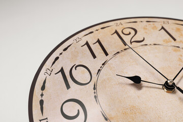 Stylish round clock on white background, closeup. Interior element