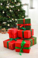 Beautifully wrapped Christmas gifts on wooden table indoors