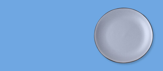 Empty light gray ceramic plate on light blue background, top view and space for text. Banner design