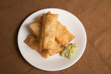 Tequenos deep fried dough and cheese fingers fast food snack with guacamole Peruvian venezuelan food