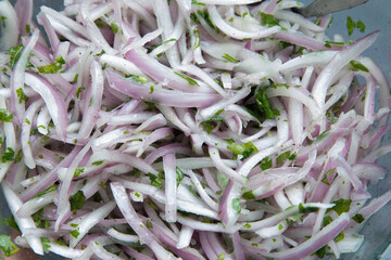 Red onion chopped in thin slices for meal preparation peruvian food zarza criolla