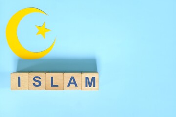 Islam religion concept. Wooden blocks word typography in blue background.