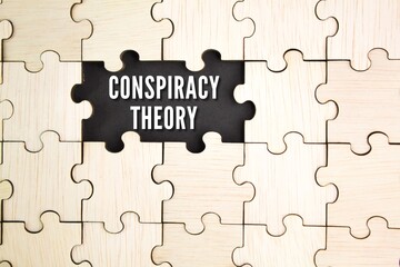 wooden puzzle with the word CONSPIRACY THEORY