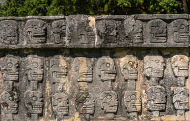 Fototapeta na wymiar The Tzompantli of Chichen Itza ruins in Mexico. The wall of skulls.