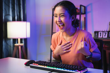 Young Asian woman gamer open mouth with emotional excited and shocked with wearing headset winning the game, celebrating victory expressing success.