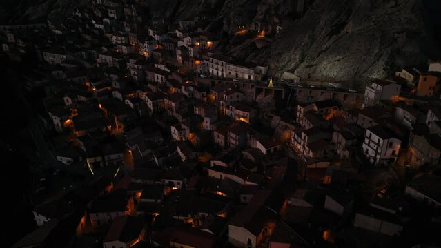 Aerial shot of a fairytale city drowned in darkness. Pietrapertosa, Italy, Europe