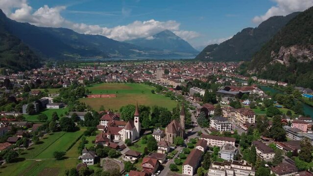 Orbiting over the mountain city of Interlaken, offering a 360 degree view. Showing the churches and it's surrounding mountains. Bernese Oberland in Bern Kanton, Switzerland