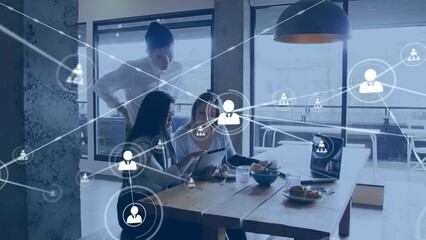 Animation of connected people icons, diverse female coworkers analyzing report over tablet in office - Powered by Adobe