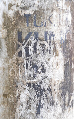 White painted metal pole with not legible text grunge texture