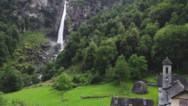 Rural village of Foroglio on Bavona valley with waterfall behind, Switzerland