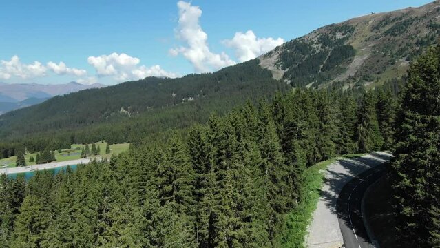 Col de la Loze road D90 with blue lake in background, France. Aerial drone panoramic view