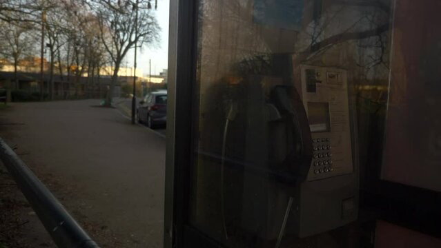 Old British Telecom Phone Box with Empty Street Daytime Trees Winter