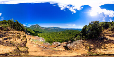 Mountains covered rainforest, trees and blue sky with clouds. Sri Lanka. Mini World's End, Pitawala...