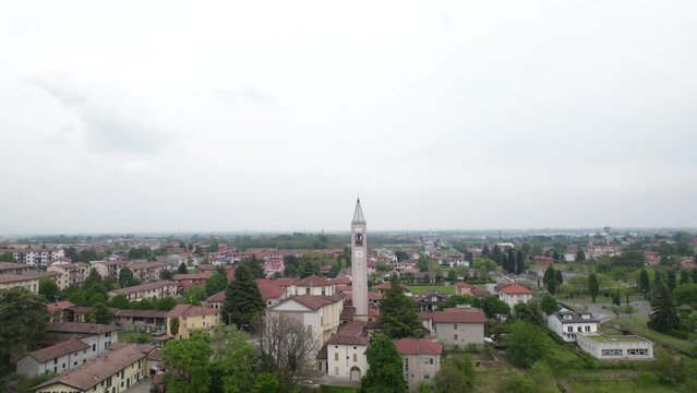Aerial establishing shot of Capriate, Italy. Town center and buildings on cloudy day.
