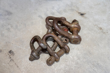 Old rust chain links on the cement background