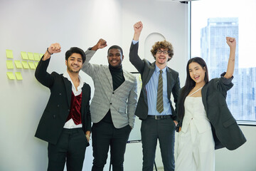 businesspeople raise arms up and celebrating success at work in the office