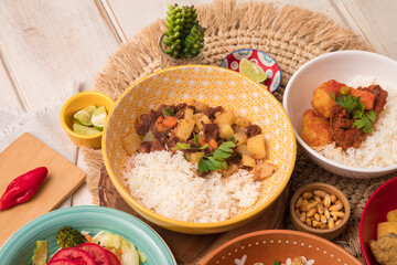 Picante de carne beef stew with potatoes Assorted food plates Peru traditional comfort food buffet table