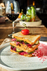 tasty sandwich with beef and wine