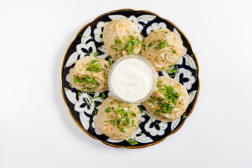 Georgian dumplings - Khinkali (Chinkali) with minced meat and herbs on a plate