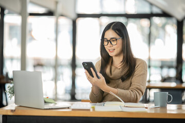 Asian woman happy with job success happy at home.