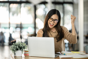 Asian woman happy with job success happy at home.