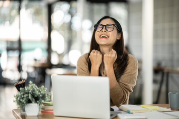 Asian woman happy with job success happy at home.