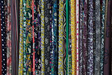 Large rows of pieces of fabric made of cotton, polyester, and other materials in different colors...