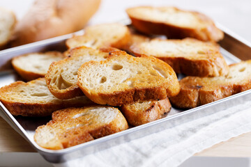 Baguette slices toasted with olive oil.