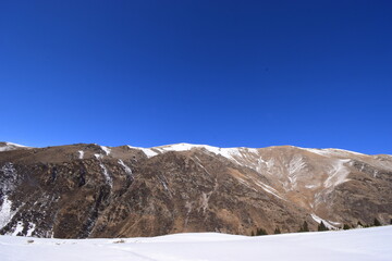 Snow-capped winter mountains of Tien Shan. snow-capped mountains on a sunny winter day. can be used as a background or advertising travel to the mountains