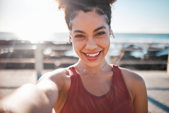 Fitness, black woman and portrait smile for selfie, vlog or profile picture by beach for running exercise. Happy African American female runner smiling for social media, memory or post by ocean coast