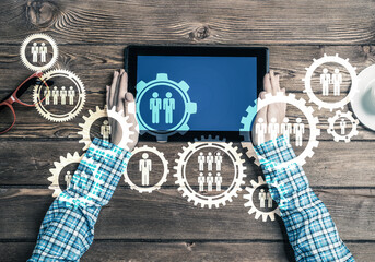 Concept of teamworking and connection with gears mechanism and tablet pc