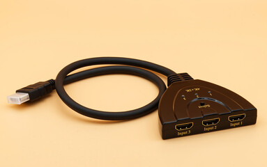 Compact HDMI switch isolated on yellow background